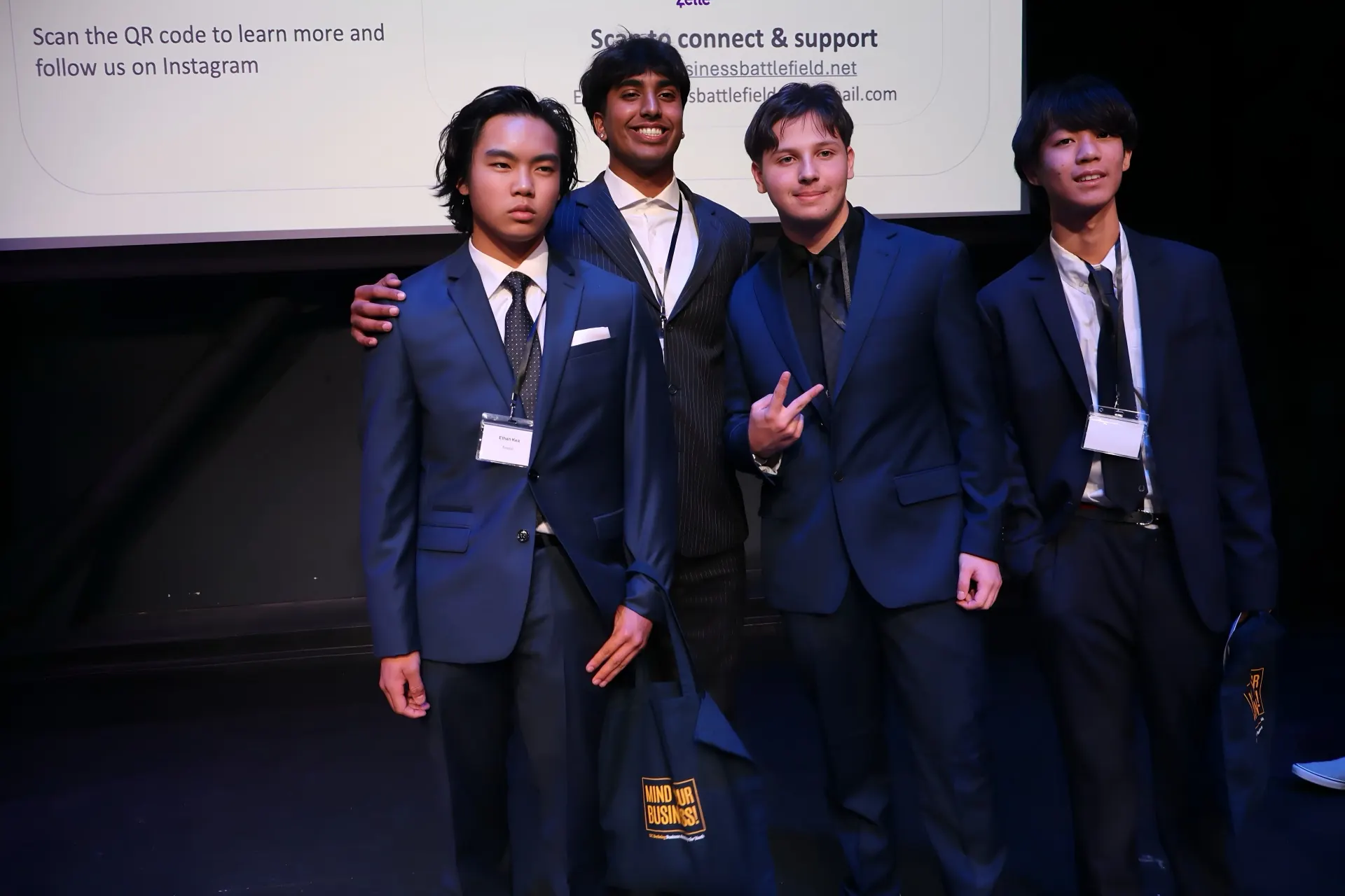 A finalist team displaying their Mind Your Business venture bag.